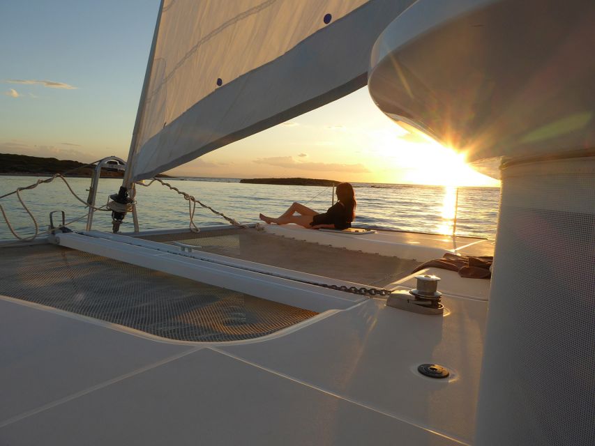 Athens: Riviera Catamaran Cruise with Meal and Drinks - Out at sea: sunbathing, welcome drinks, and sail time